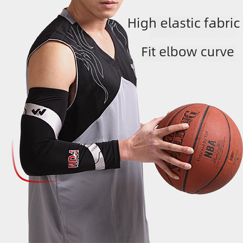 Player holding a basketball while wearing a black arm sleeve
